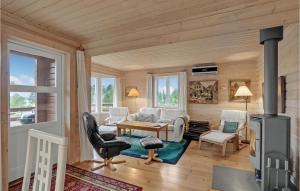 una sala de estar con chimenea en una casa de madera en 3 Bedroom Nice Home In Hjslev, en Højslev