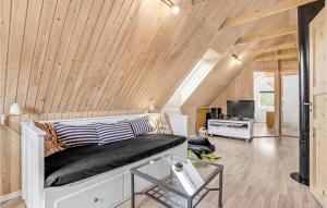 a bedroom with a bed in a room with wooden ceilings at Holiday Home Koubjerg Iii in Toftum +20 photos