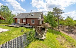 una pequeña casa en una colina con una valla en 3 Bedroom Nice Home In Hjslev, en Højslev