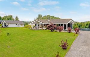a house with a large lawn in front of it at 3 Bedroom Amazing Home In Rudkbing in Spodsbjerg