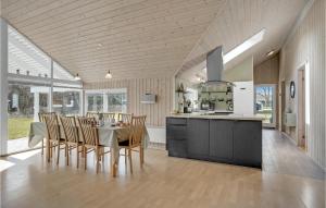 a kitchen and dining room with a table and chairs at Stunning Home In Vggerlse With 4 Bedrooms And Sauna in Bøtø By