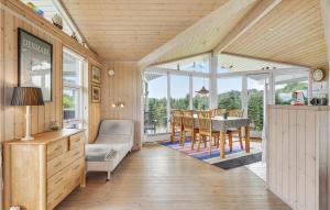 a kitchen and dining room with a table and chairs at Holiday Home Skovridervænget Denm in Spodsbjerg