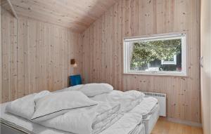 a bedroom with a bed in a wooden wall at Holiday Home Mågelunden Rødby Ii in Kramnitse +24 photos