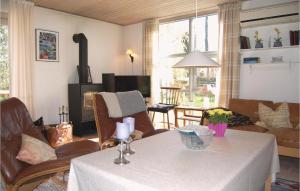 sala de estar con mesa y sofá en Cozy Home In Tranekr With Kitchen, en Hou