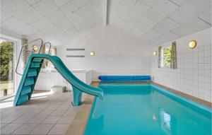 a swimming pool with a slide in a house at Gorgeous Home In Sydals With Indoor Swimming Pool in Høruphav