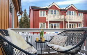 a balcony with two chairs and a table and a building at Nordseter Sportell 271 in Lillehammer