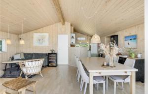 a kitchen and living room with a table and chairs at Cozy Home In Knebel With House Sea View in Knebel