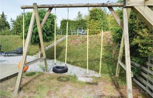 a tire on a swing in a playground at Amazing Home In Ebeltoft With Sauna in Ebeltoft