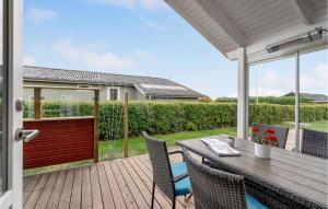 a patio with a table and chairs on a deck at Lovely Home In Faaborg With Wifi in Fåborg