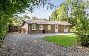 a brick house with a garage and a yard at Awesome Home In Toftlund With Kitchen in Arrild