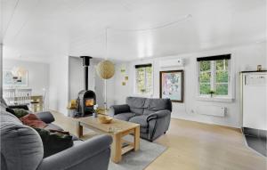 a living room with two couches and a table at Awesome Home In Toftlund With Kitchen in Arrild