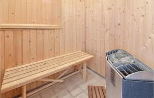 a sauna with a bench and a trash can at Holiday Home Strandparken Otterup Vi in Otterup
