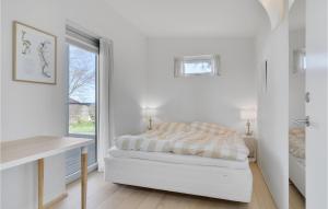 A bed or beds in a room at Gorgeous Home In Dronningmlle With House Sea View