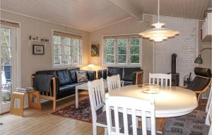 a living room with a table and a couch at 3 Bedroom Pet Friendly Home In Aakirkeby in Vester Sømarken