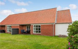 a brick house with an orange roof and a yard at Stunning Home In Ribe With Wifi in Ribe