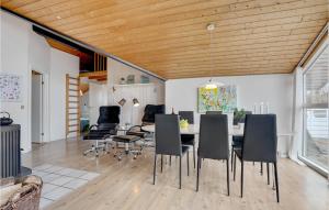 a dining room and living room with a table and chairs at Stunning Home In Vestervig With 3 Bedrooms, Sauna And Wifi in Vestervig