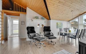 a dining room with a table and chairs at Holiday Home Gunhildsvej Vestervig Vi in Vestervig
