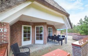 a patio with chairs and a table on a brick building at Holiday Home Rømø 60 in Rømø