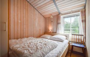 a bedroom with a bed in a room with a window at Holiday Home Rømø 60 in Rømø Kirkeby