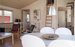 a dining room with a white table and chairs at 2 Bedroom Gorgeous Home In Gudhjem in Gudhjem