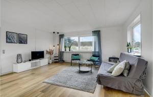 a living room with a couch and a tv at Stunning Home In Hvide Sande With Kitchen in Hvide Sande