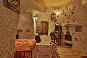 a bedroom with a bed and a desk in a room at Travel Inn Cave Hotel in Goreme