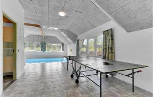 a ping pong table in the middle of a room at Beautiful Home In Ringkbing With 5 Bedrooms, Sauna And Indoor Swimming Pool in Søndervig