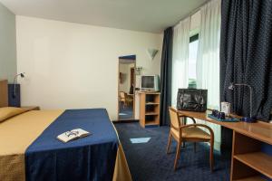 Postel nebo postele na pokoji v ubytování Hotel Mastai