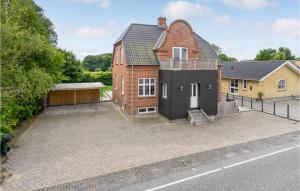 an exterior view of a house with a large driveway at Six-Bedroom Holiday Home In Bagenkop in Bagenkop