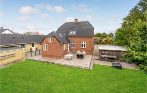 a house with a large backyard with a deck at Six-Bedroom Holiday Home In Bagenkop in Bagenkop