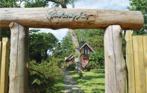 an archway into a garden with a house in the background at Two-Bedroom Holiday Home In Gilleleje in Gilleleje
