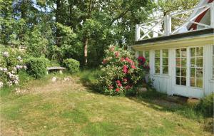 a house with a garden with flowers in the yard at Two-Bedroom Holiday Home In Gilleleje in Gilleleje