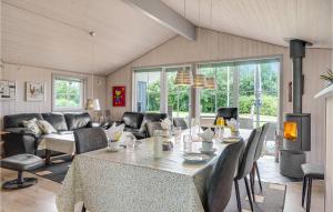 a living room with a table and chairs at 3 Bedroom Stunning Home In Hemmet in Hemmet