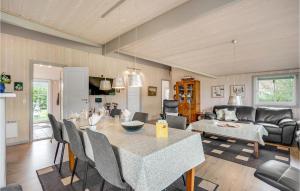 a kitchen and living room with a table and chairs at 3 Bedroom Stunning Home In Hemmet in Hemmet