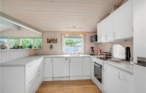 a white kitchen with white cabinets and a sink at 3 Bedroom Stunning Home In Hemmet in Hemmet +8 photos