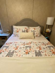Una cama con un edredón con un letrero de casa. en Your Own Cozy Tiny Home, en Austell