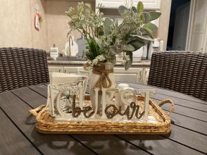 una cesta con un jarrón de flores sobre una mesa en Your Own Cozy Tiny Home, en Austell