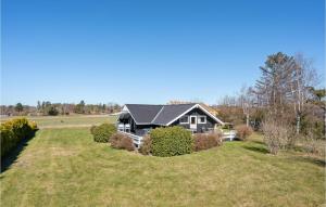 a house on a large grassy field with a house at Beautiful Home In lsted With Kitchen in Ølsted