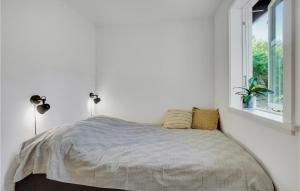 a white bedroom with a bed and a window at 2 Bedroom Cozy Home In Stenlille in Ruds-Vedby