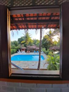 una ventana con vistas a la piscina en Residencial Alto do Arraial, en Arraial d'Ajuda
