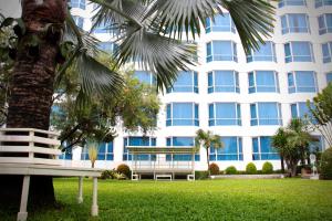 a palm tree in front of a building at Millennium Hotel Sirih Jakarta in Jakarta