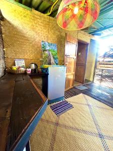 a room with a table with a refrigerator in it at Deep House Sea View in Ko Lanta