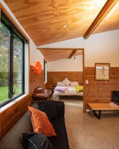 a living room with a couch and a table at River Road Retreat in Nelson