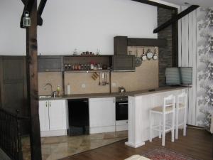 a kitchen with white cabinets and a counter top at Kapana Plovdiv in Plovdiv