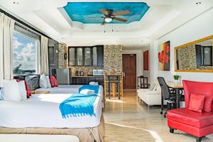 a bedroom with two beds and a living room at Paradise Beachfront & Nightlife Heart in Cancún