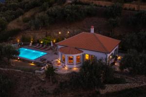 an aerial view of a house with a swimming pool at Avgi Villa in Glossa