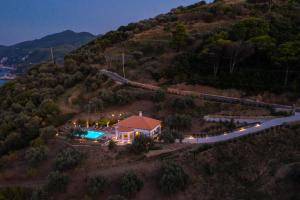 an aerial view of a house on a hill with a pool at Avgi Villa in Glossa