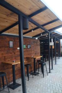 a row of tables and chairs in a room with wooden walls at Villa Konzuli in Bitola