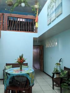 a dining room with a table and a staircase at Guesthouse Casa Lapa2 in Alajuela