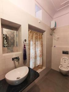 a bathroom with a sink and a toilet at Friend India in Jaipur